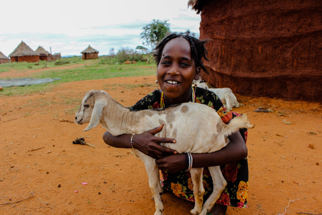A Borana girl holds a young goat in Yabello, Ethiopia.